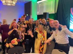 a group shot of the quiz team with me dressed as a hot dog