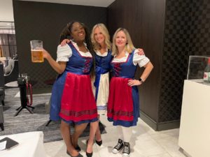 three women dressed in dirndl outfits